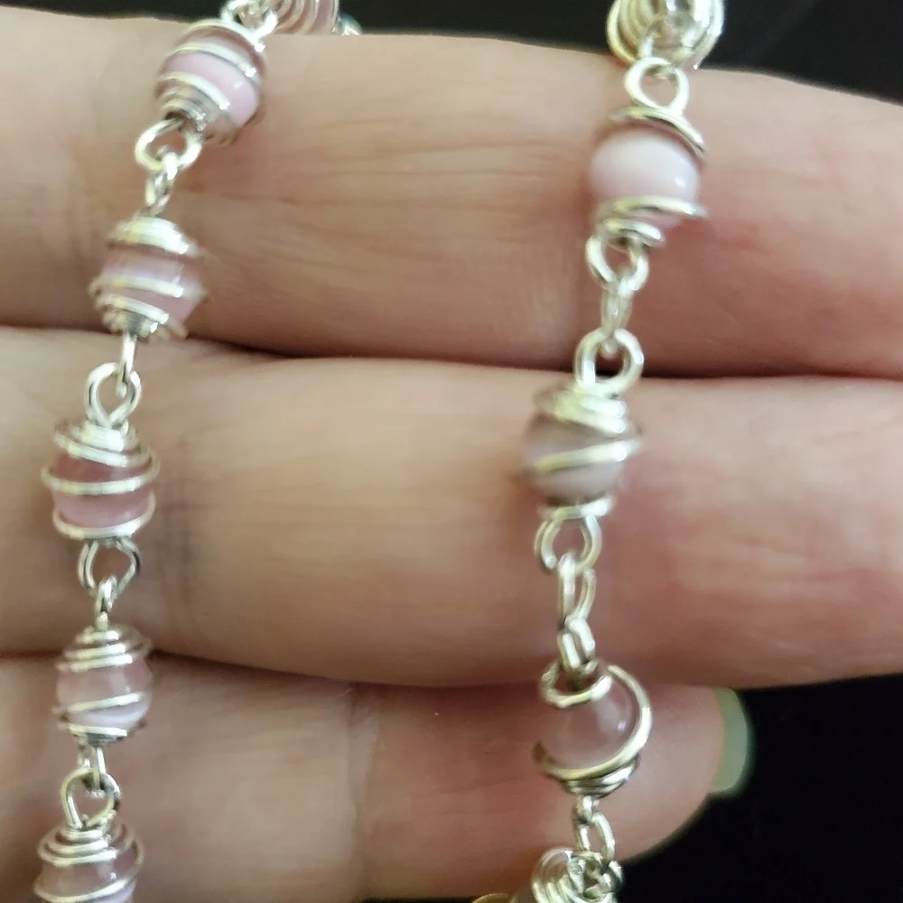 Two silver with pink pearl stones
